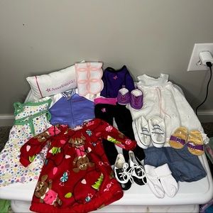 A bundle of American girl doll clothes and shoes